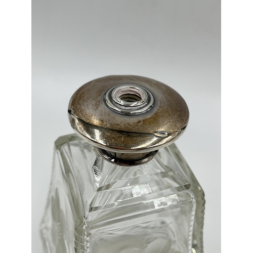 284 - Three cut glass scent bottles with sterling silver tops to include Victorian bottle, dated 1886 - ap... 