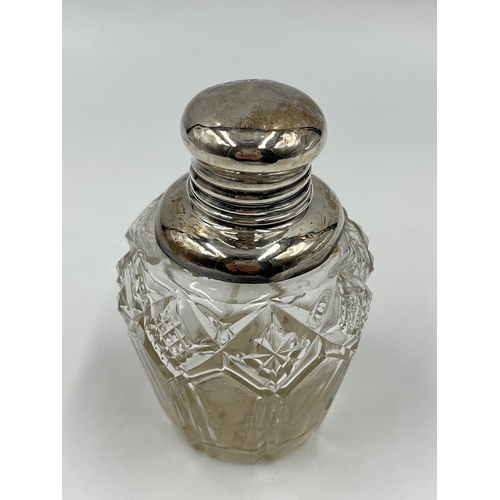 284 - Three cut glass scent bottles with sterling silver tops to include Victorian bottle, dated 1886 - ap... 