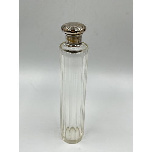 284 - Three cut glass scent bottles with sterling silver tops to include Victorian bottle, dated 1886 - ap... 