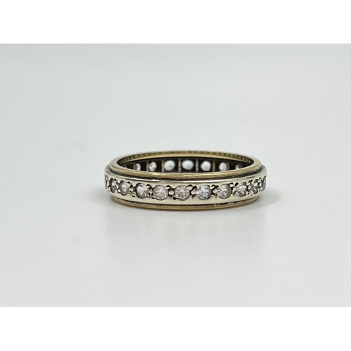 2332 - A two tone yellow and white metal CZ stone eternity ring, size P - approx. gross weight 3.34 grams