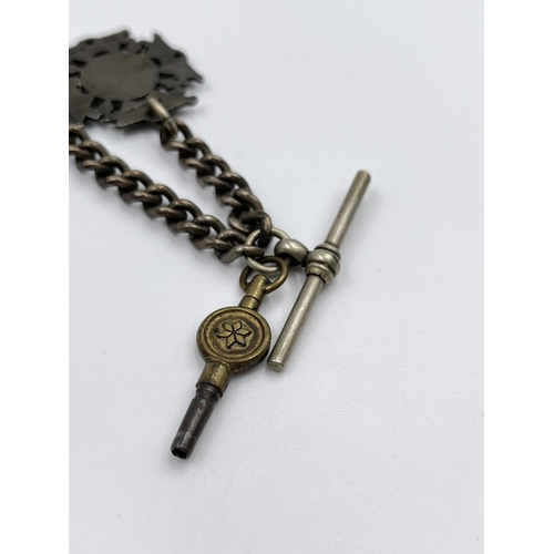 2348 - An antique white metal 29cm Albert chain with T bar, key and hallmarked Birmingham silver fob, dated... 