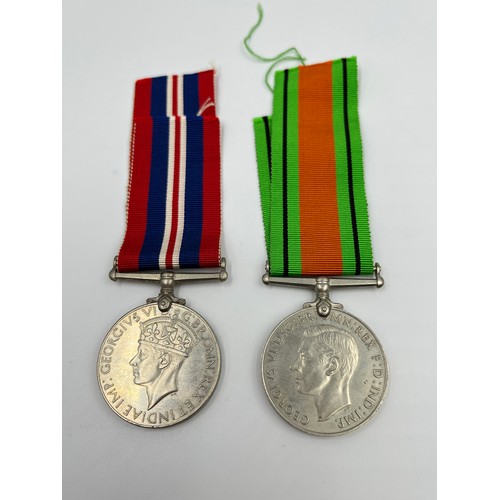 65 - Three items, two WWII British medals, Defence and War with paperwork and ribbons and one 1965 Winsto... 