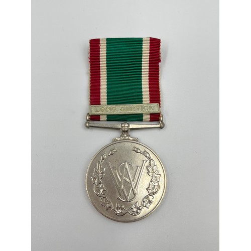 65B - A cased Women's voluntary service medal with certificate and gold plated badge