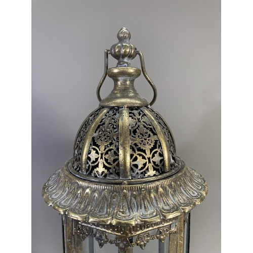 510 - A pair of Middle Eastern style brass effect and glass lanterns - approx. 55cm high