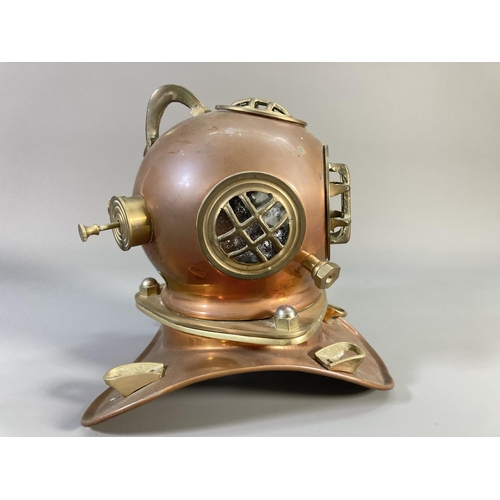 511 - A 19th century style copper and brass miniature divers helmet - approx. 19cm high