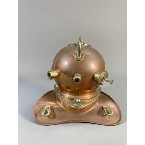 511 - A 19th century style copper and brass miniature divers helmet - approx. 19cm high