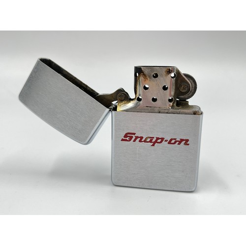 123 - Three assorted Zippo cigarette lighters, one Cunard, one Snap-On and one other