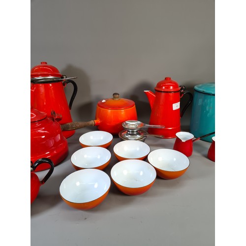 532 - A collection of mid 20th century enamel kitchenware to include red coffee pot, green circular storag... 