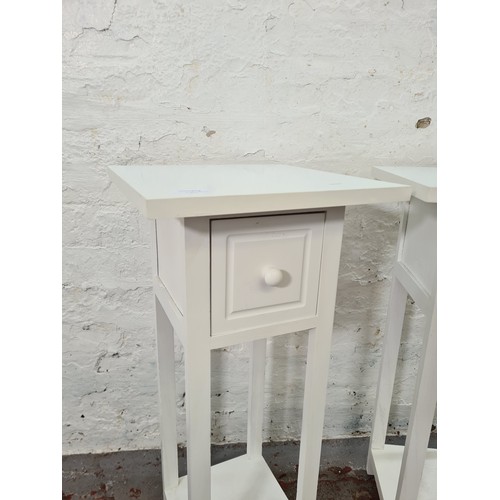 1176B - A pair of modern white painted square top two-tier bedside tables - approx. 71cm high x 32cm square