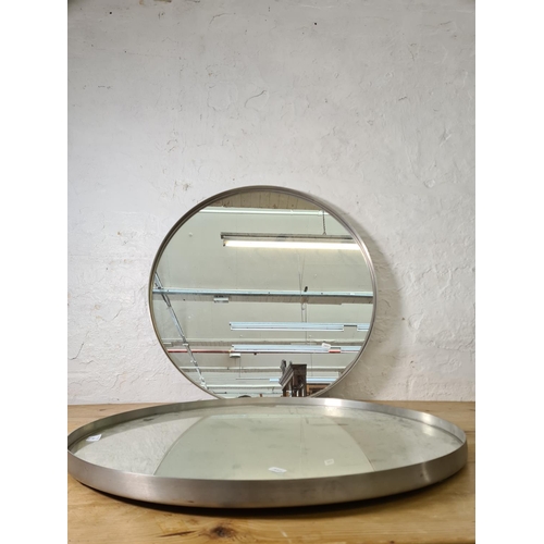 1198 - A pair of industrial style brushed steel framed circular wall mirrors - both approx. 70cm diameter