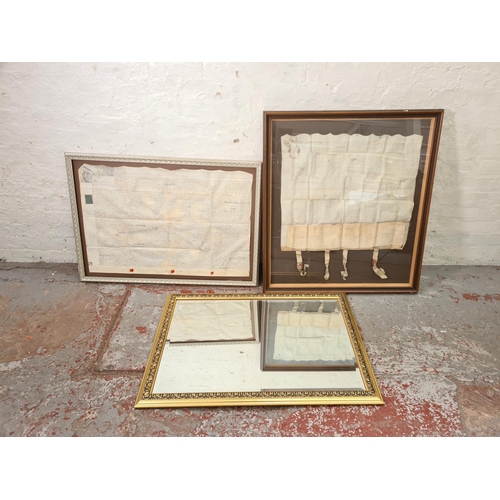 1202 - Three items, one gilt framed bevelled edge mirror and two antique framed indentures - largest approx... 