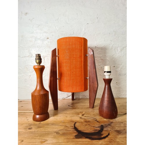 1157A - Three teak table lamps, two 1960s - largest approx. 34cm high and one mid 20th century style with or... 