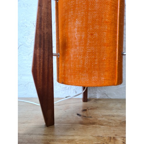 1157A - Three teak table lamps, two 1960s - largest approx. 34cm high and one mid 20th century style with or... 