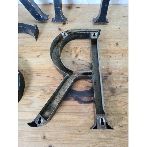 528 - Four vintage black painted aluminium shop display letters - approx. 38cm high