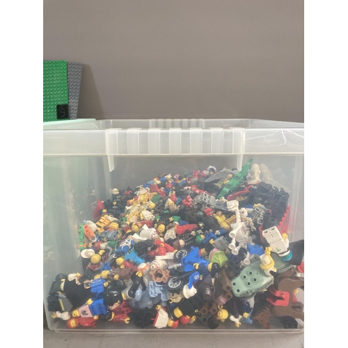 676 - Two boxes and one display case containing a large quantity of Lego figures and building blocks