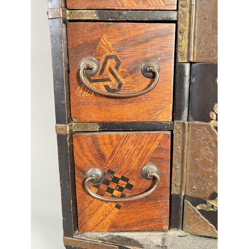 818 - An early/mid 20th century Japanese marquetry and lacquered table top jewellery cabinet with mother o... 