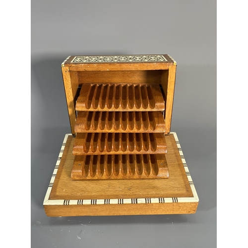 820 - A mid 20th century teak and beech mosaic inlaid musical cigarette dispenser - approx. 10cm high x 17... 