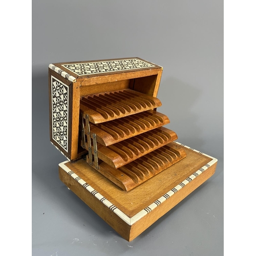 820 - A mid 20th century teak and beech mosaic inlaid musical cigarette dispenser - approx. 10cm high x 17... 