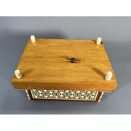 820 - A mid 20th century teak and beech mosaic inlaid musical cigarette dispenser - approx. 10cm high x 17... 