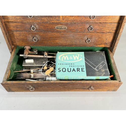 825 - A 1940s Fearcleve Products of Cheltenham oak cased seven drawer engineer's tool chest containing a l... 