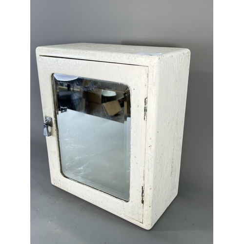 826 - A mid 20th century white painted wooden bathroom cabinet with bevelled edge mirror and internal glaz... 