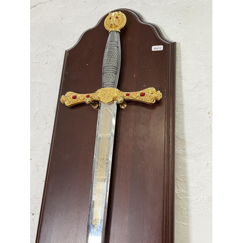 833 - An ornamental King Arthur's Excalibur sword on mahogany plaque - sword approx. 109cm long x 24cm wid... 