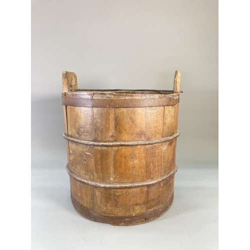 841 - An antique wooden and iron banded water bucket - approx. 37.5cm high x 31cm diameter