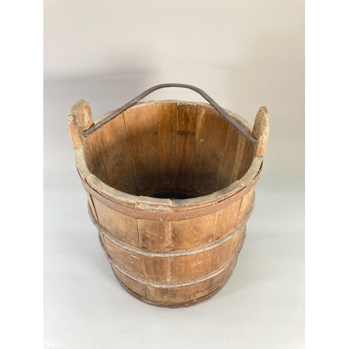 841 - An antique wooden and iron banded water bucket - approx. 37.5cm high x 31cm diameter