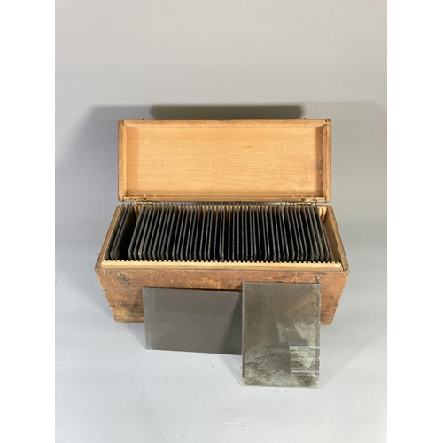 844 - A stained pine box containing approx. 48 glass plate negatives