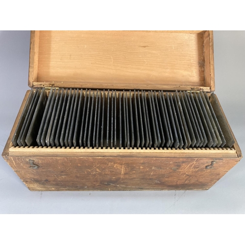 844 - A stained pine box containing approx. 48 glass plate negatives