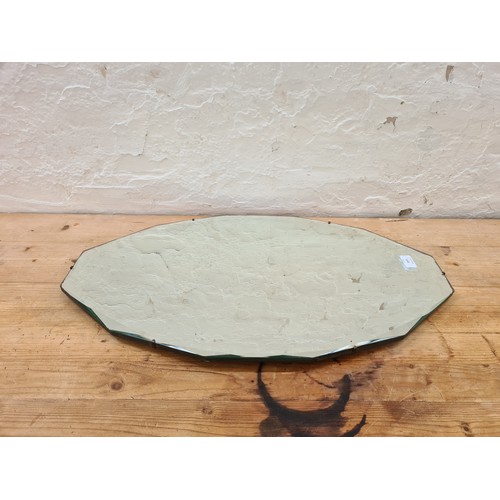 1143 - An early/mid 20th century bevelled edge wall hanging mirror - approx. 41cm high x 69cm wide