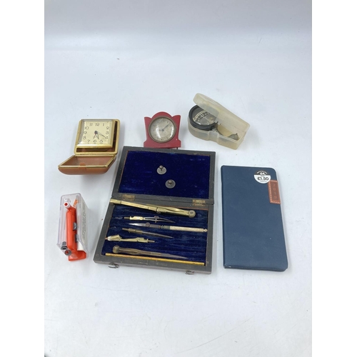 800 - A collection of assorted items to include mid 20th century Postilion brass cased quartz mantel clock... 