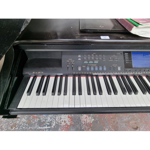 1394 - A Yamaha Clavinova CVP-96 electric piano with a selection of sheet music and instruction manual