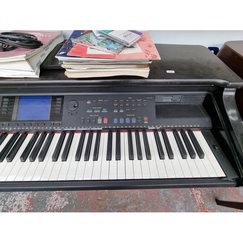 1394 - A Yamaha Clavinova CVP-96 electric piano with a selection of sheet music and instruction manual