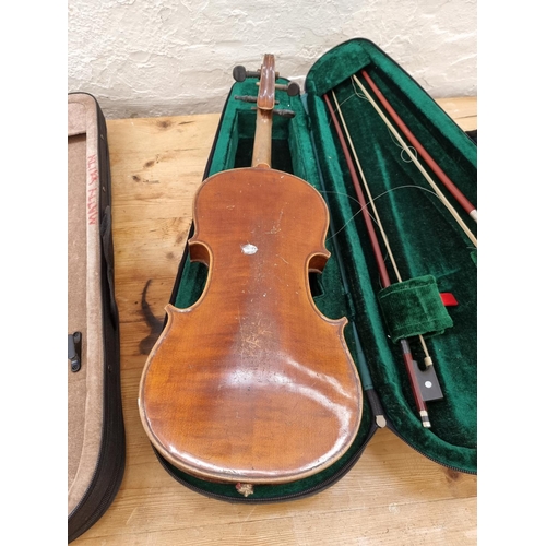 1395 - Three items, one vintage full size violin, one half size violin case containing two bows and one cas... 