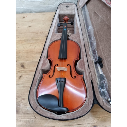 1395 - Three items, one vintage full size violin, one half size violin case containing two bows and one cas... 