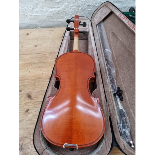 1395 - Three items, one vintage full size violin, one half size violin case containing two bows and one cas... 