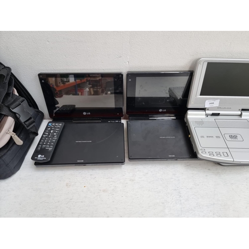 1433 - A collection of portable DVD players to include LG, Bush BDVD8380 and Wharfedale WDP-127