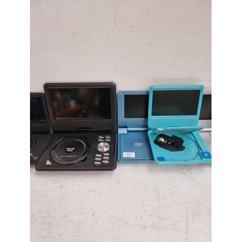 1434 - A collection of portable DVD players to include Curtis DVD7014UK, Alba CDVD7SWP with remote control,... 