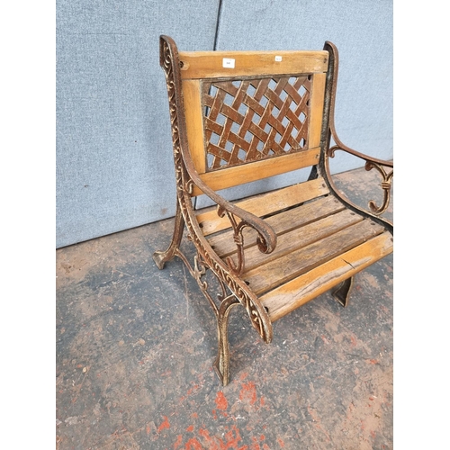 1640 - A cast iron and wooden slatted garden chair - approx. 78.5cm high x 61cm wide