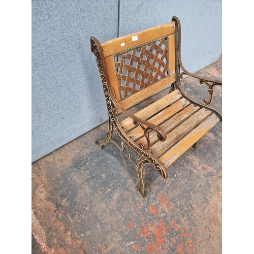 1641 - A cast iron and wooden slatted garden chair - approx. 78.5cm high x 61cm wide