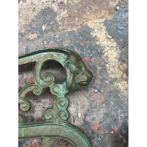 1689 - A pair of cast iron bench ends