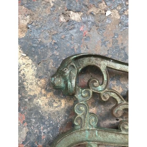 1689 - A pair of cast iron bench ends