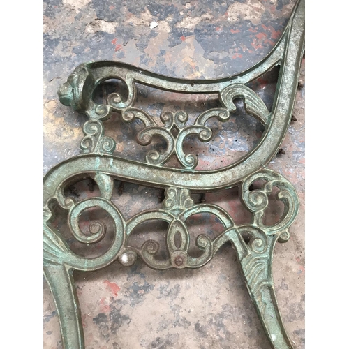 1689 - A pair of cast iron bench ends