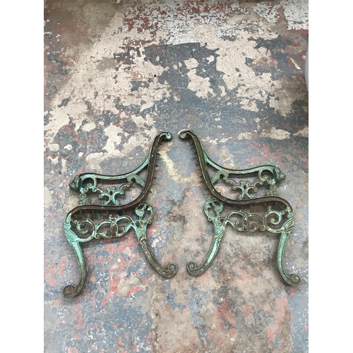 1689 - A pair of cast iron bench ends