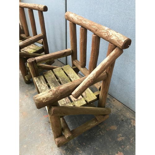 1694 - A pair of pine garden chairs - approx. 92cm high x 79cm long x 57cm deep