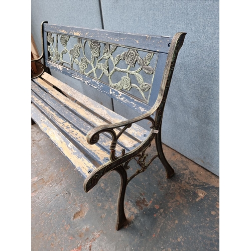 1706 - A cast iron and wooden slatted garden bench