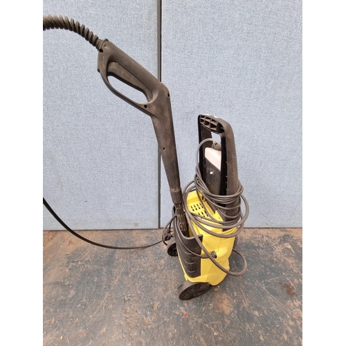 1708 - An unbranded pressure washer with hose and lance