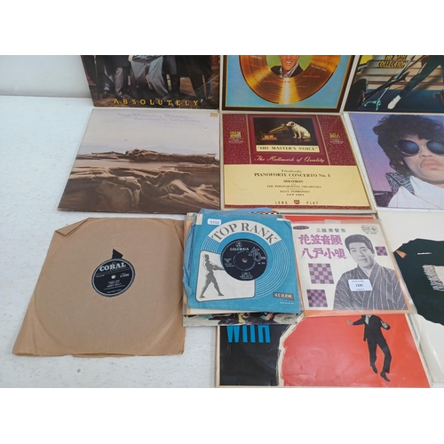 1335 - A collection of vinyl records to include Elvis Presley, Prince, Madness, Plastic Bertrand, Buzzcocks... 