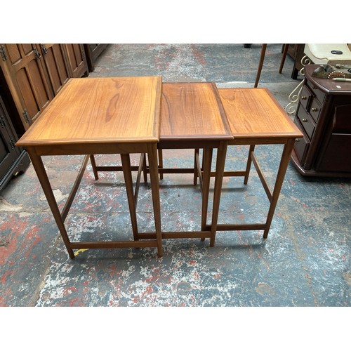 1038A - A teak nest of three tables - largest approx. 52cm high x 54cm wide x 39cm deep